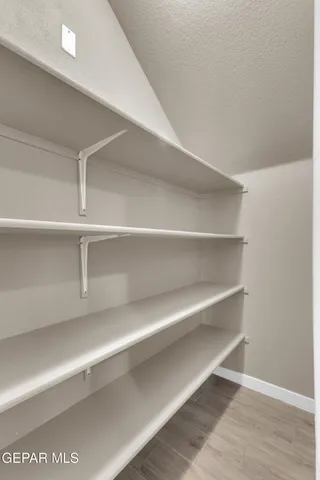 a view of walk in closet with empty racks