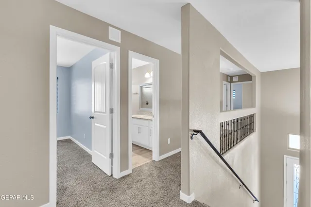 a view of a hallway with two rooms