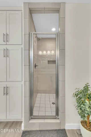 a bathroom with a glass shower door