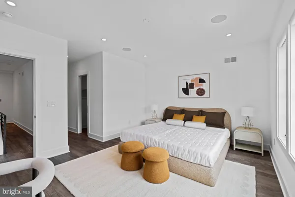 a view of a hallway with wooden floor and furniture