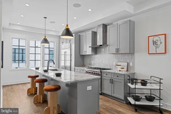 a kitchen with a sink a stove and cabinets