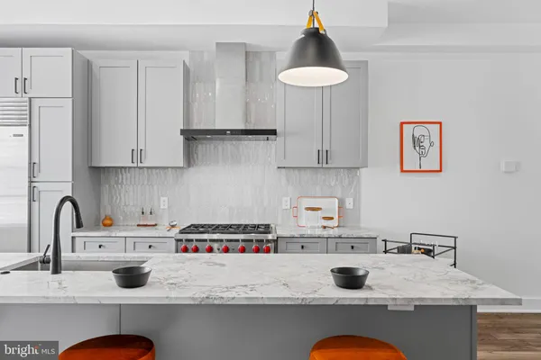 a kitchen with granite countertop a sink stove and cabinets