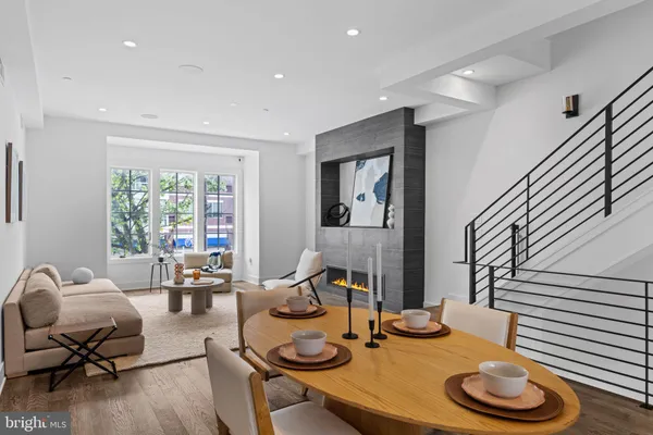 a dining room with furniture and wooden floor