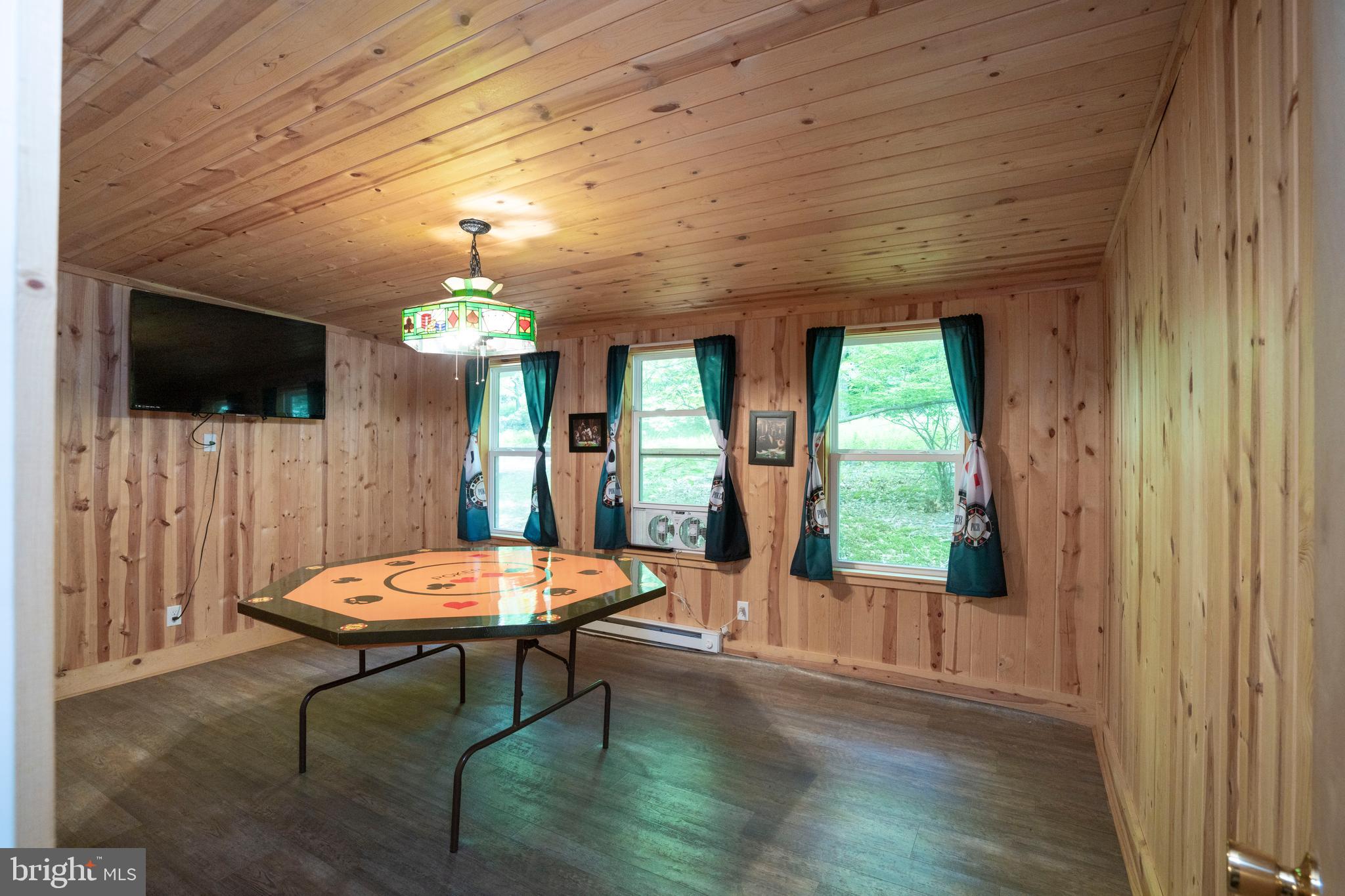 385 Elk Creek Road Aaronsburg, PA 16820 - Photo 31 of 71 a living room with a table chairs and a chandelier