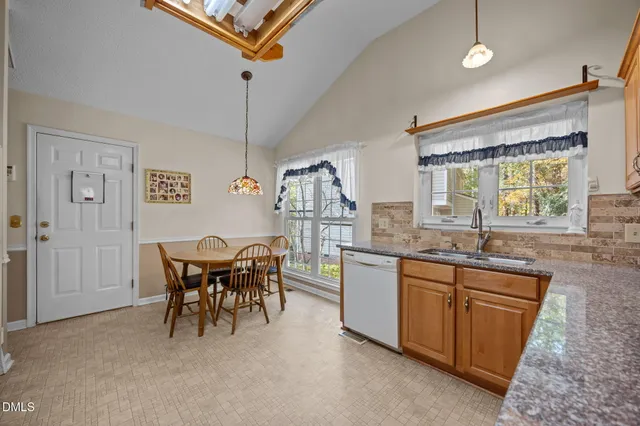a kitchen with stainless steel appliances granite countertop sink stove and refrigerator