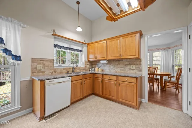 a kitchen with stainless steel appliances a stove a refrigerator and white cabinets