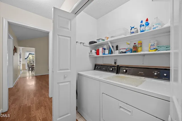 a bedroom with a bed and a lamp on dresser