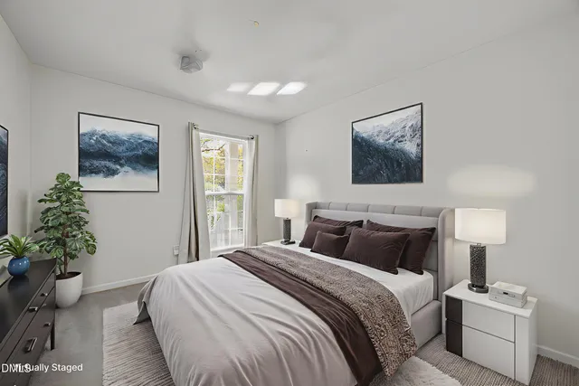 a view of an empty room and a chandelier fan