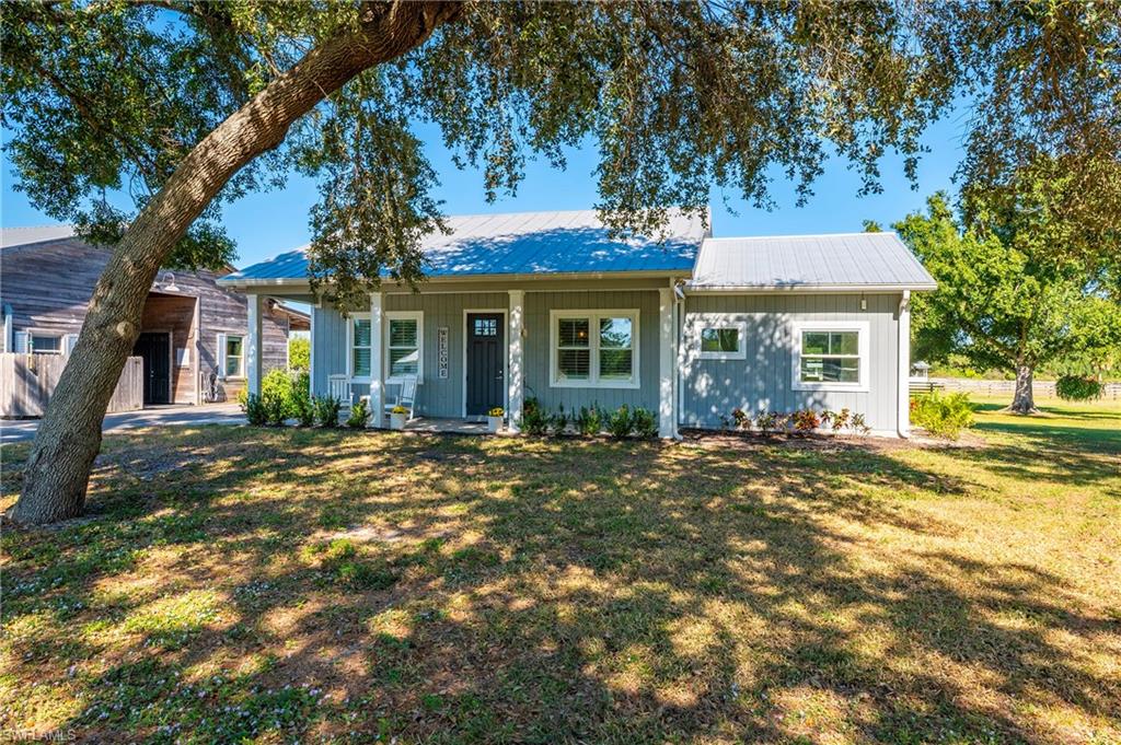 10910 Ruden Road North Fort Myers, FL 33917 - Photo 17 of 48 a view of a house with a tree in front of it