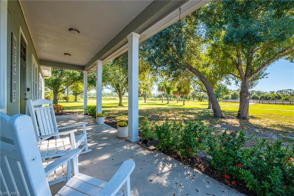 10910 Ruden Road North Fort Myers, FL 33917 - Photo 18 of 48 a view of a porch with furniture and garden