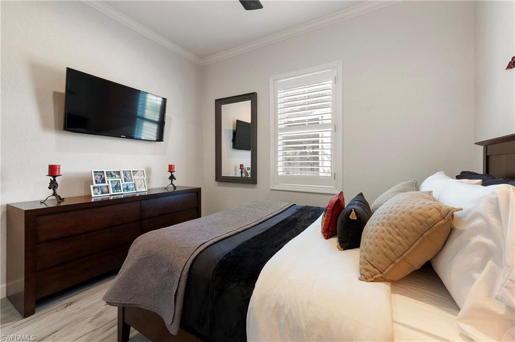 10910 Ruden Road North Fort Myers, FL 33917 - Photo 19 of 48 a bedroom with a bed and a flat screen tv