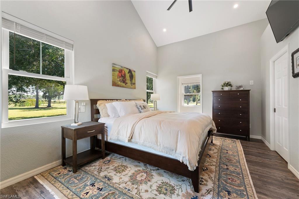 10910 Ruden Road North Fort Myers, FL 33917 - Photo 22 of 48 a bedroom with a bed and wooden floor