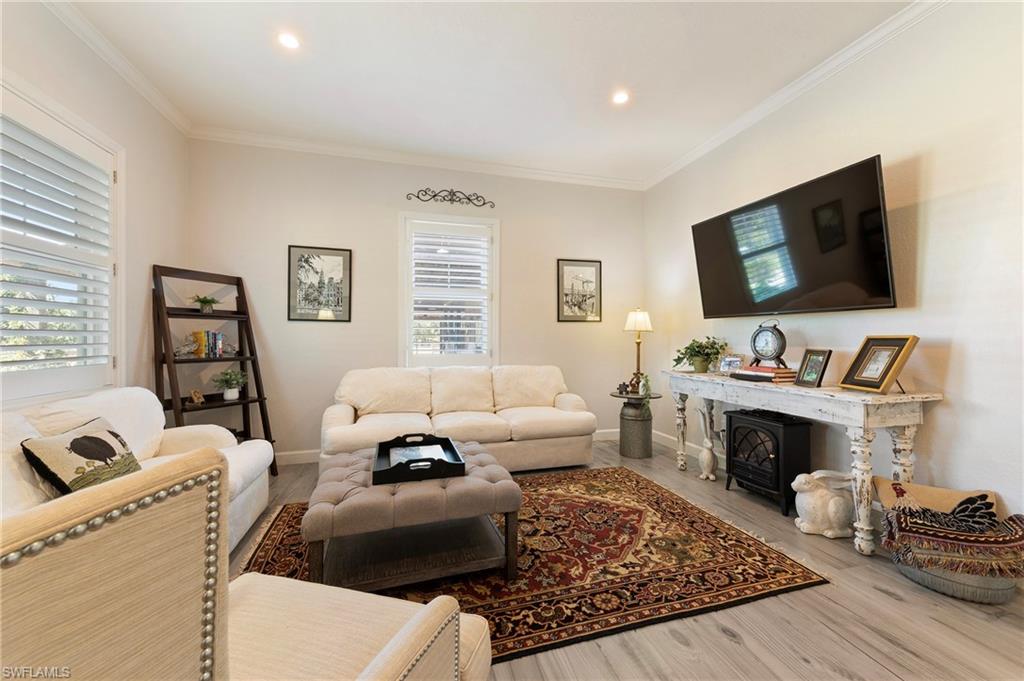 10910 Ruden Road North Fort Myers, FL 33917 - Photo 27 of 48 a living room with furniture and a fireplace