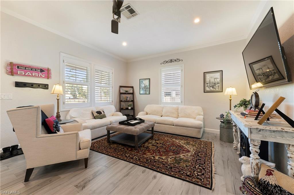 10910 Ruden Road North Fort Myers, FL 33917 - Photo 28 of 48 a living room with furniture and a flat screen tv