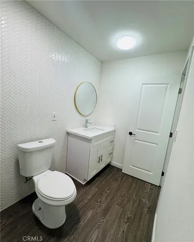 a bathroom with a toilet sink and a mirror