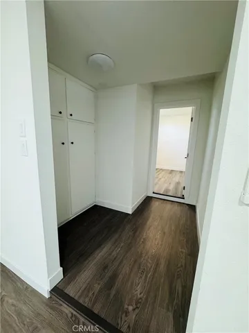 a view of an empty room and wooden floor