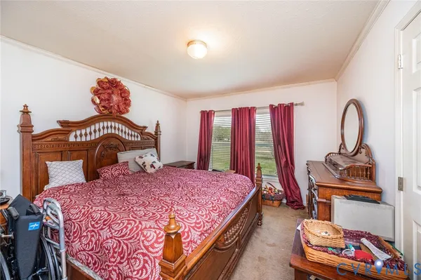 a bedroom with a bed and a dresser in it