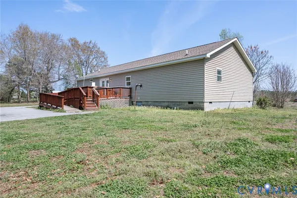 a backyard of a house with wooden fence and large trees