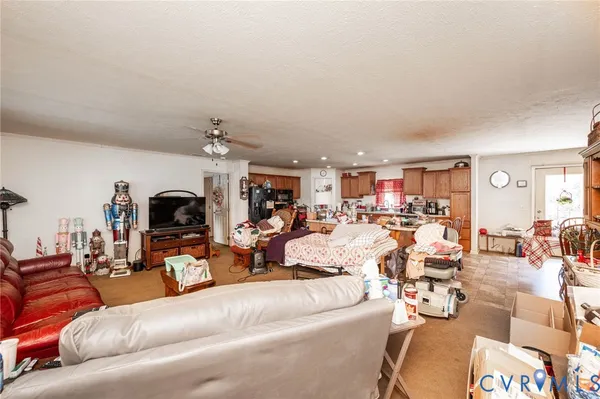 a living room with furniture kitchen view and a fireplace