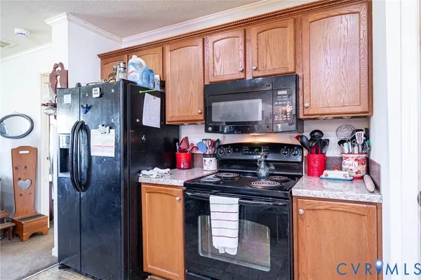 a kitchen with stainless steel appliances granite countertop a stove refrigerator sink and cabinets