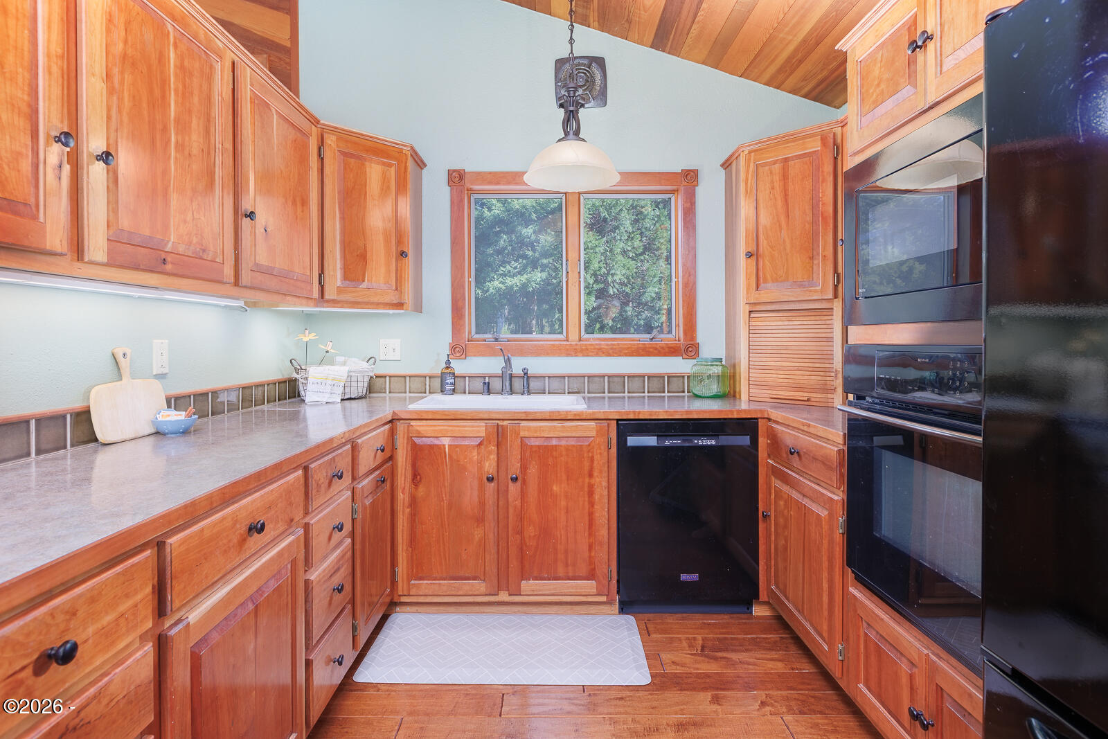 871 Old River Road Northeast Siletz, OR 97380 - Photo 17 of 86 Kitchen with Cherry Cabinets