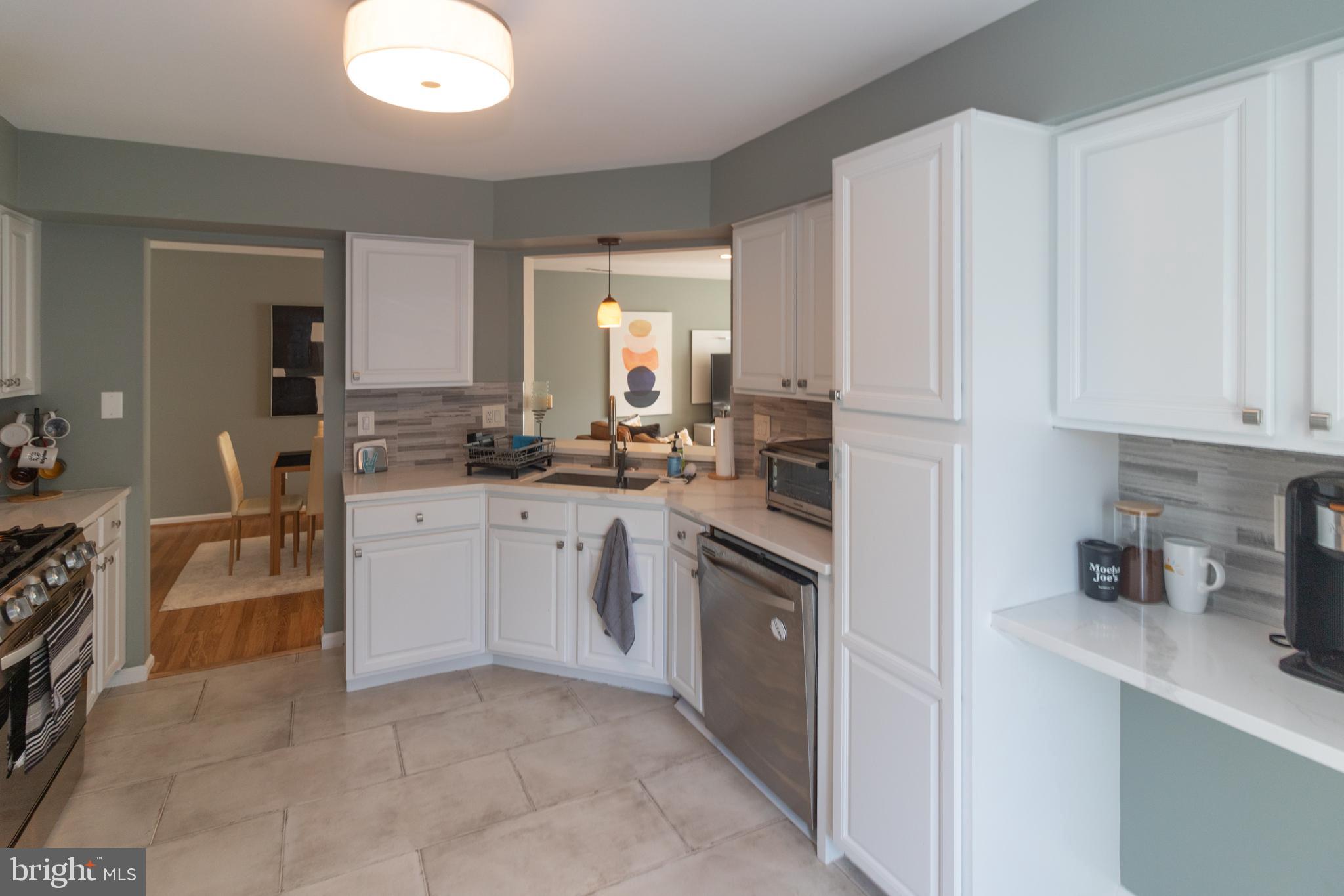 705 Oliphant Lane Mount Laurel, NJ 08054 - Photo 14 of 28 a kitchen with a sink stove and cabinets