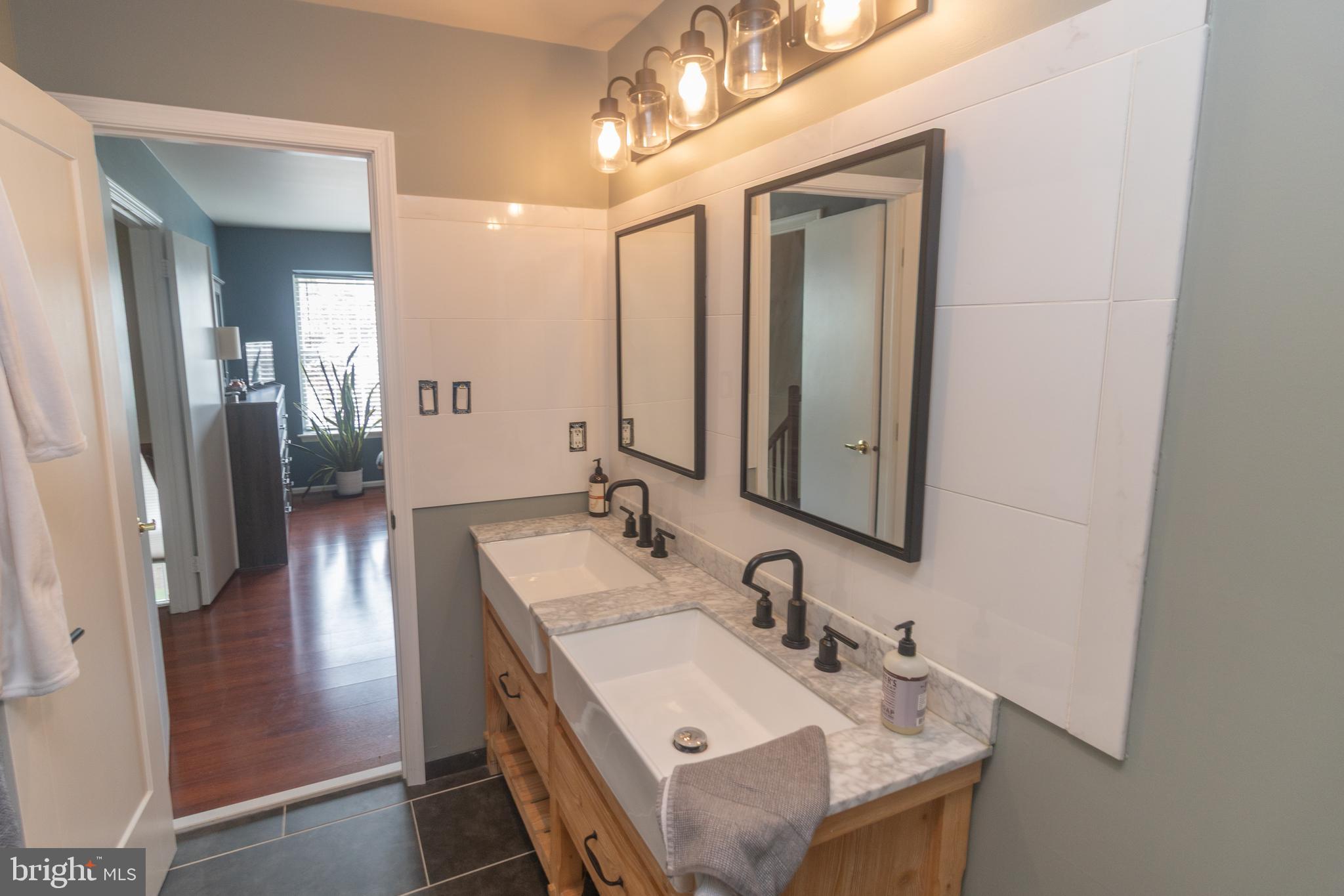 705 Oliphant Lane Mount Laurel, NJ 08054 - Photo 20 of 28 a en suite bathroom with a granite countertop sink a mirror and a shower