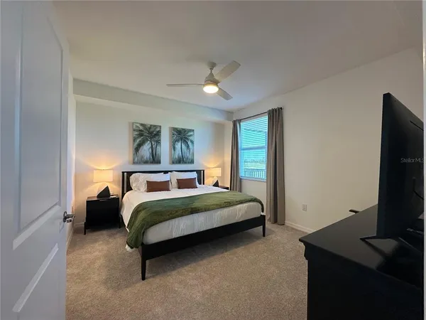 a bedroom with a bed and a flat screen tv