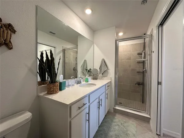 a bathroom with a double vanity sink toilet and mirror