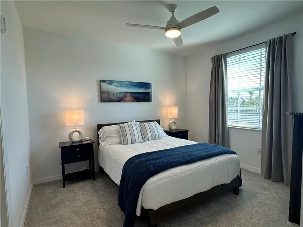 a bedroom with a bed and a window