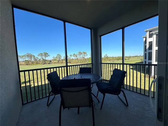 a view of a balcony with chair and a barbeque