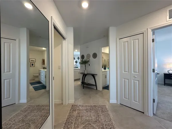 a view of a hallway with bathroom and closet