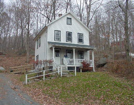 36 Georgetown Road Weston, CT 06883 - Photo 1 of 1 a front view of a house with plants and chairs