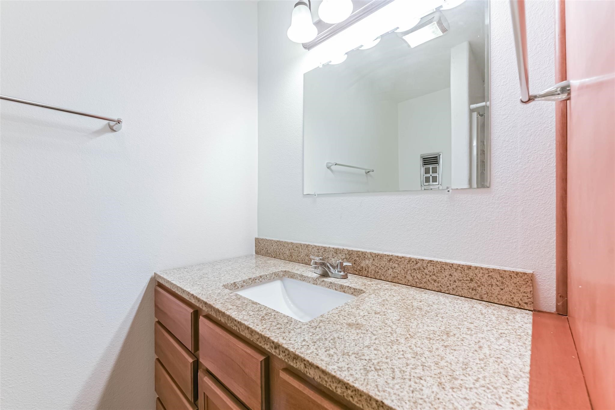 12002 Palmcroft Street Houston, TX 77034 - Photo 14 of 16 a bathroom with a granite countertop sink and a mirror