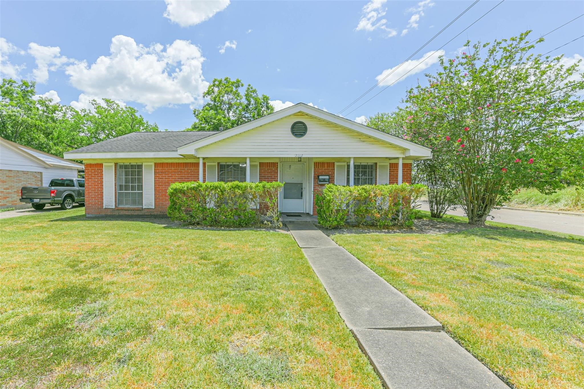 12002 Palmcroft Street Houston, TX 77034 - Photo 2 of 16 a front view of a house with garden
