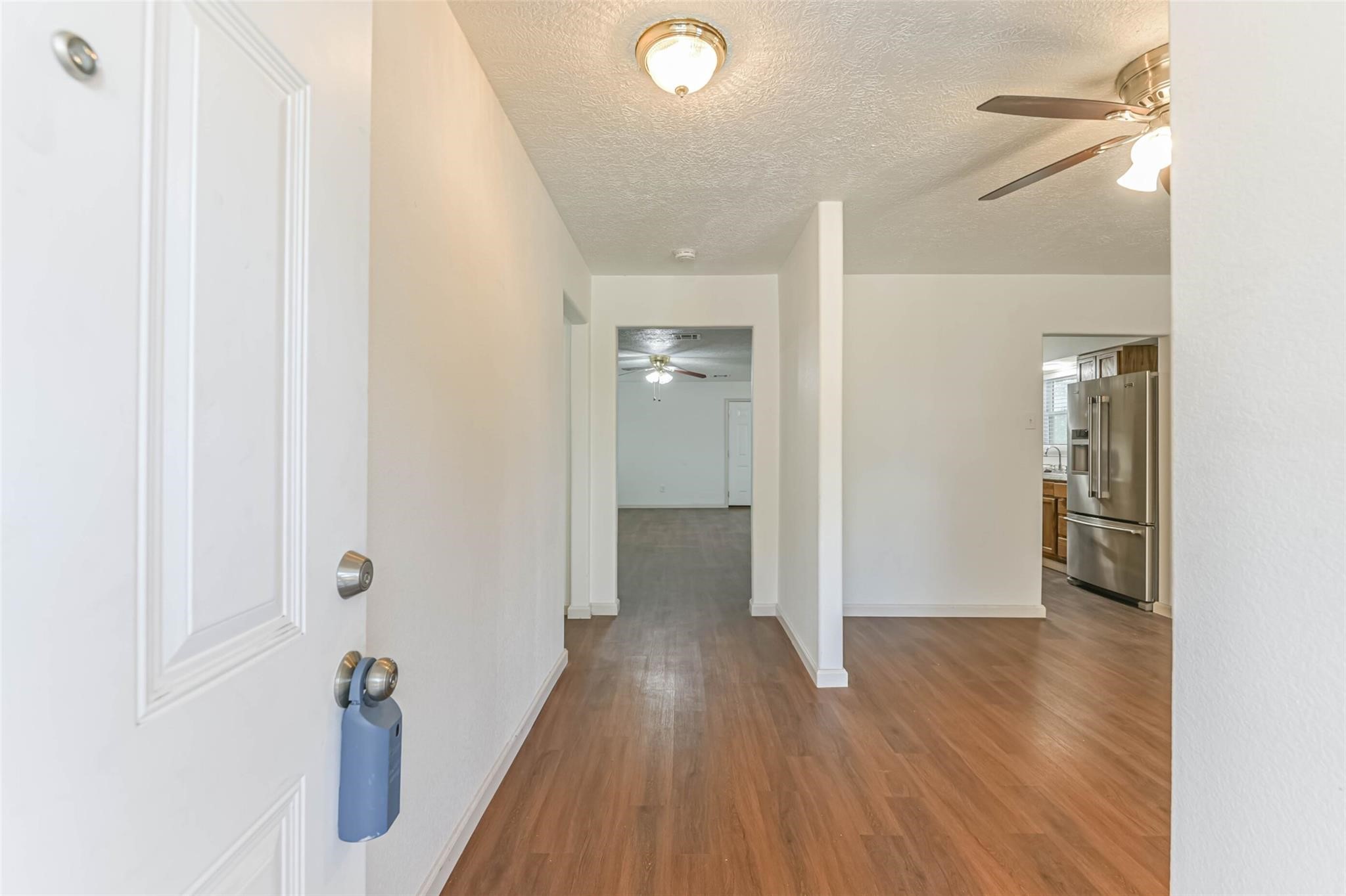 12002 Palmcroft Street Houston, TX 77034 - Photo 3 of 16 a view of a hallway with wooden floor