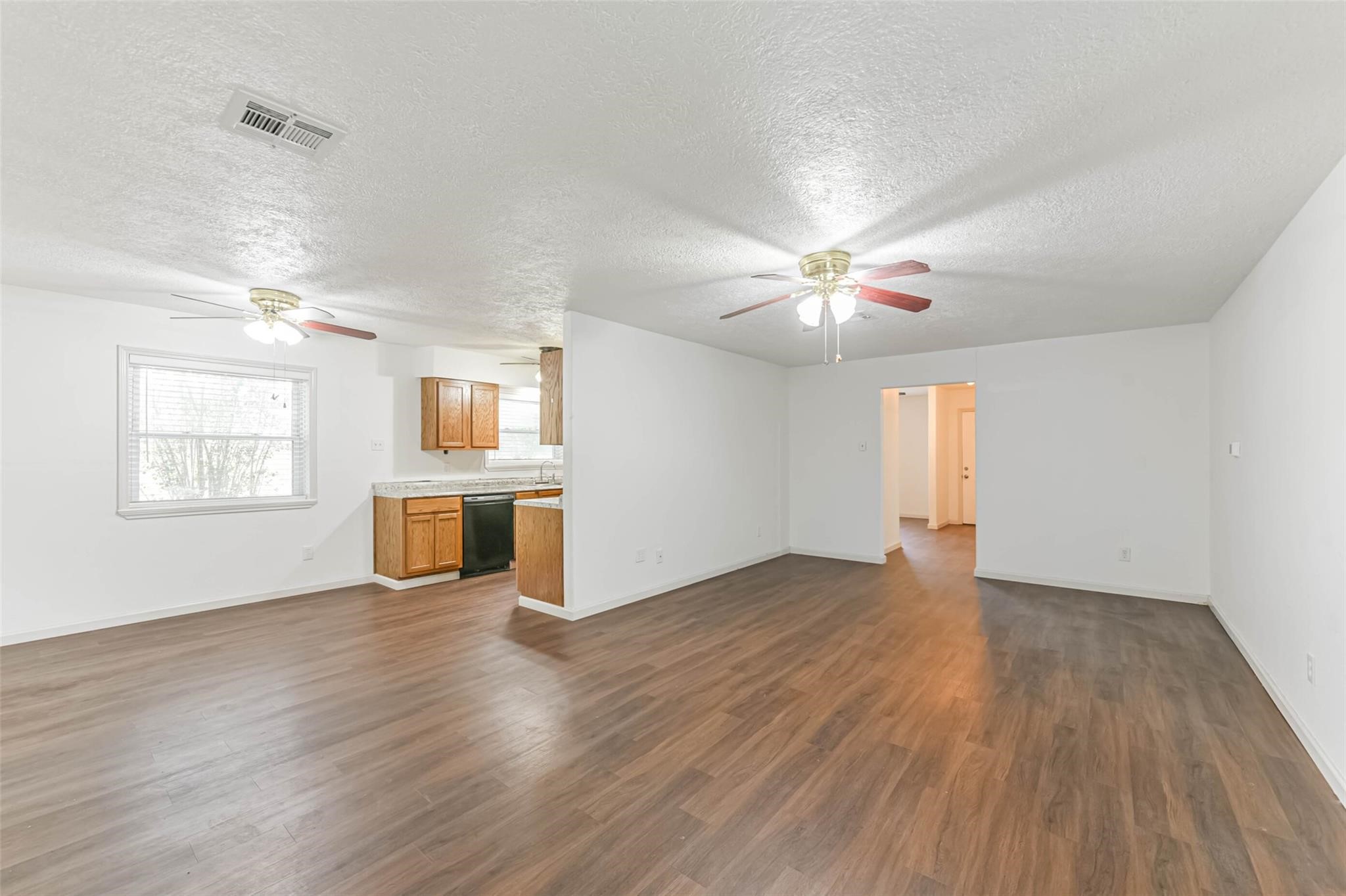12002 Palmcroft Street Houston, TX 77034 - Photo 7 of 16 a view of an empty room with a window and wooden floor
