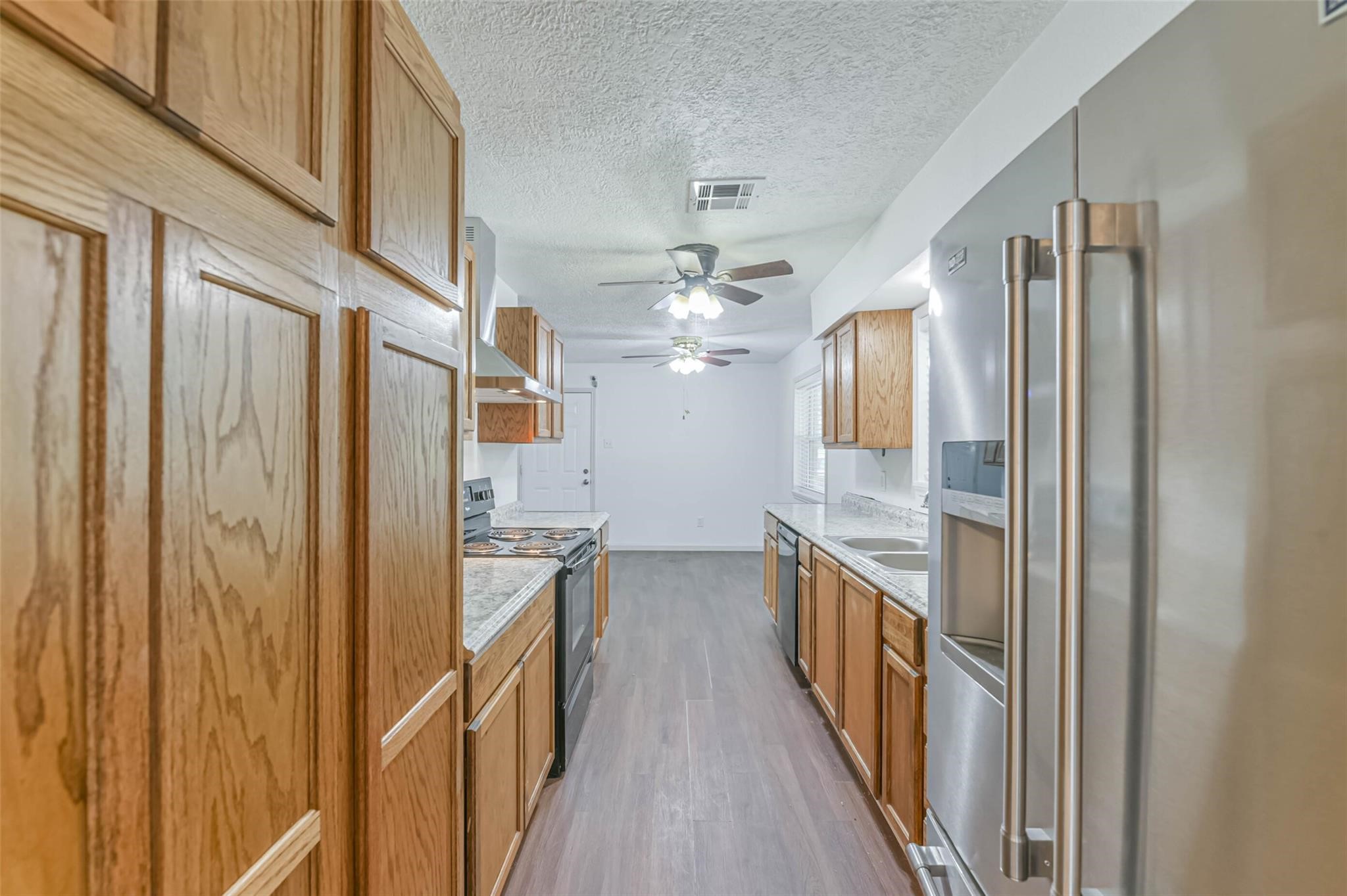 12002 Palmcroft Street Houston, TX 77034 - Photo 9 of 16 a view of a hallway with wooden floor and cabinets
