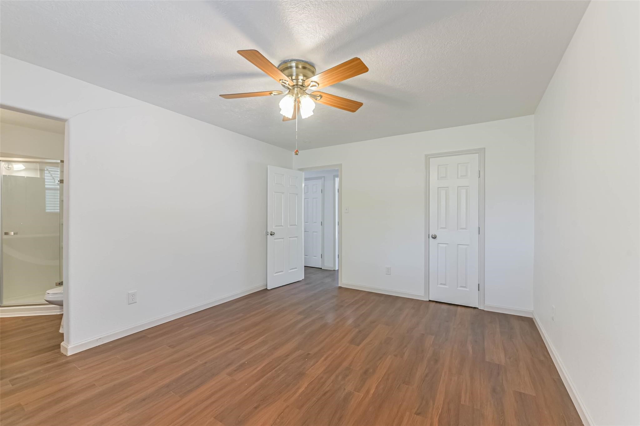 12002 Palmcroft Street Houston, TX 77034 - Photo 10 of 16 a view of an empty room with wooden floor