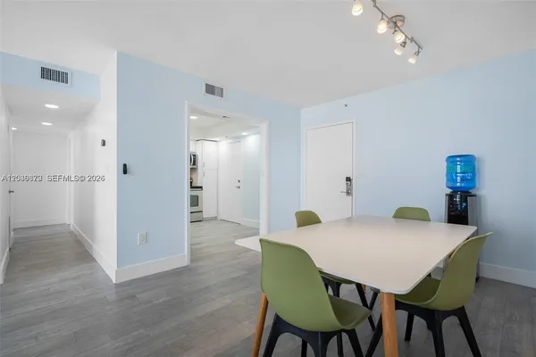 a view of a dining room with furniture and wooden floor