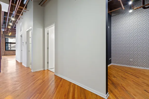 a view of hallway with wooden floor