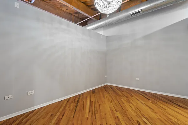 a view of a room with wooden floor and white walls