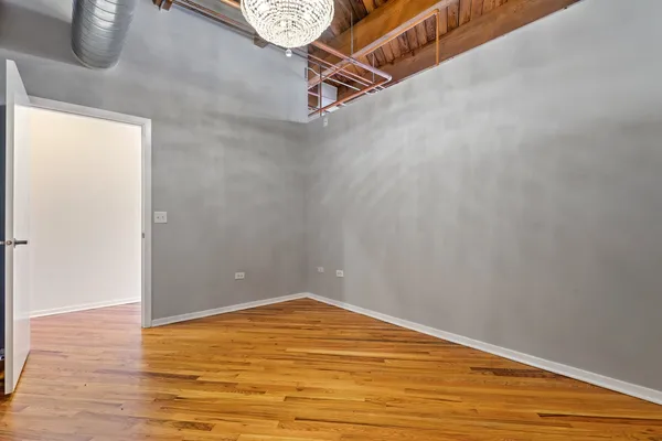 a view of a room with wooden floor