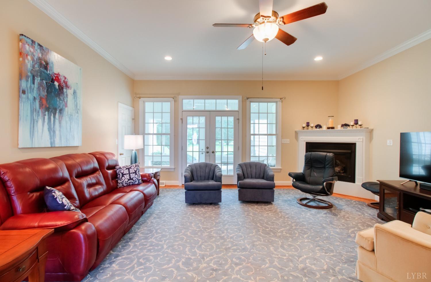 1228 Doyles Run Forest, VA 24551 - Photo 28 of 87 a living room with furniture ceiling fan and a fireplace