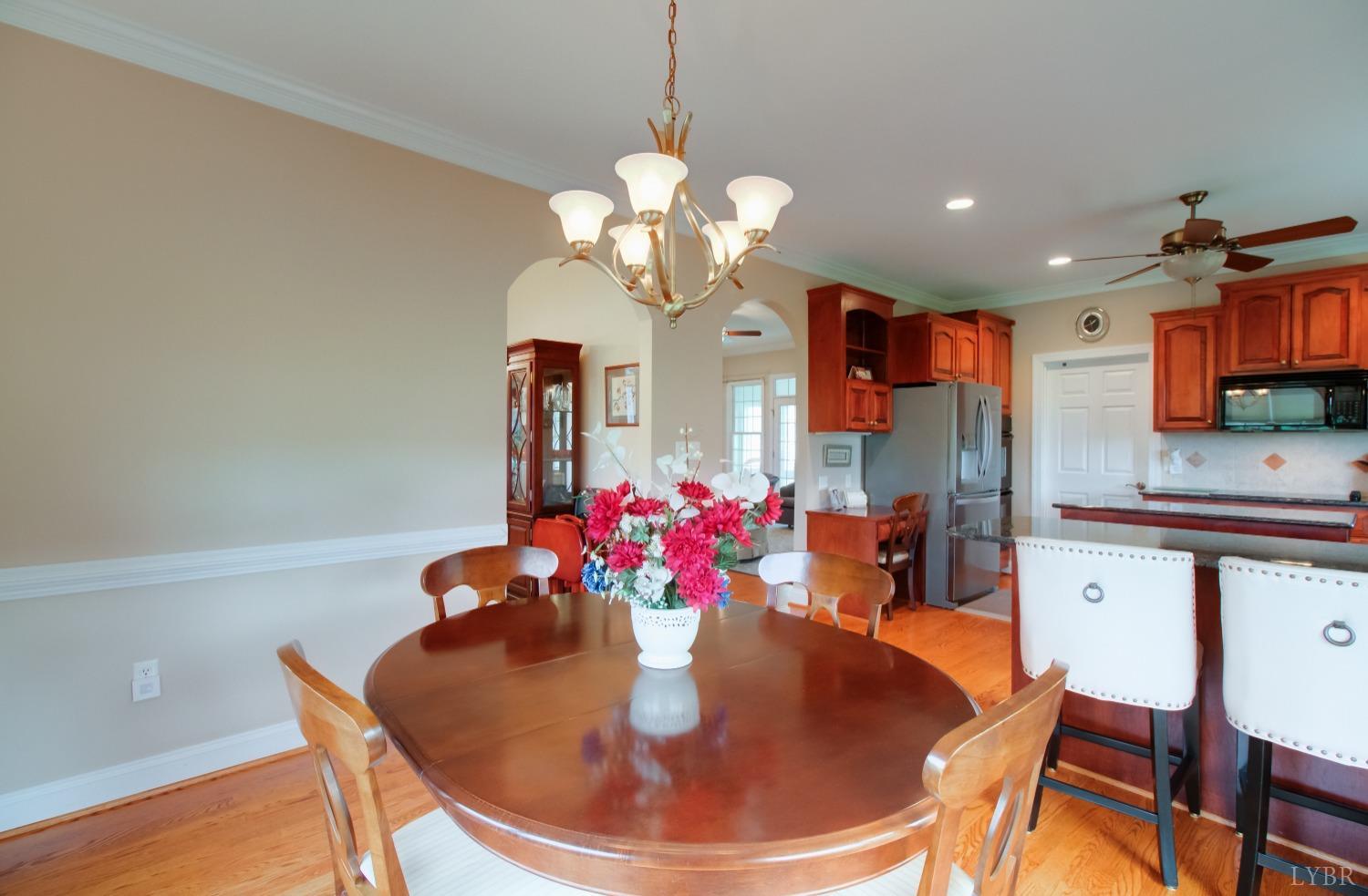 1228 Doyles Run Forest, VA 24551 - Photo 36 of 87 a dining room with furniture a chandelier and kitchen view