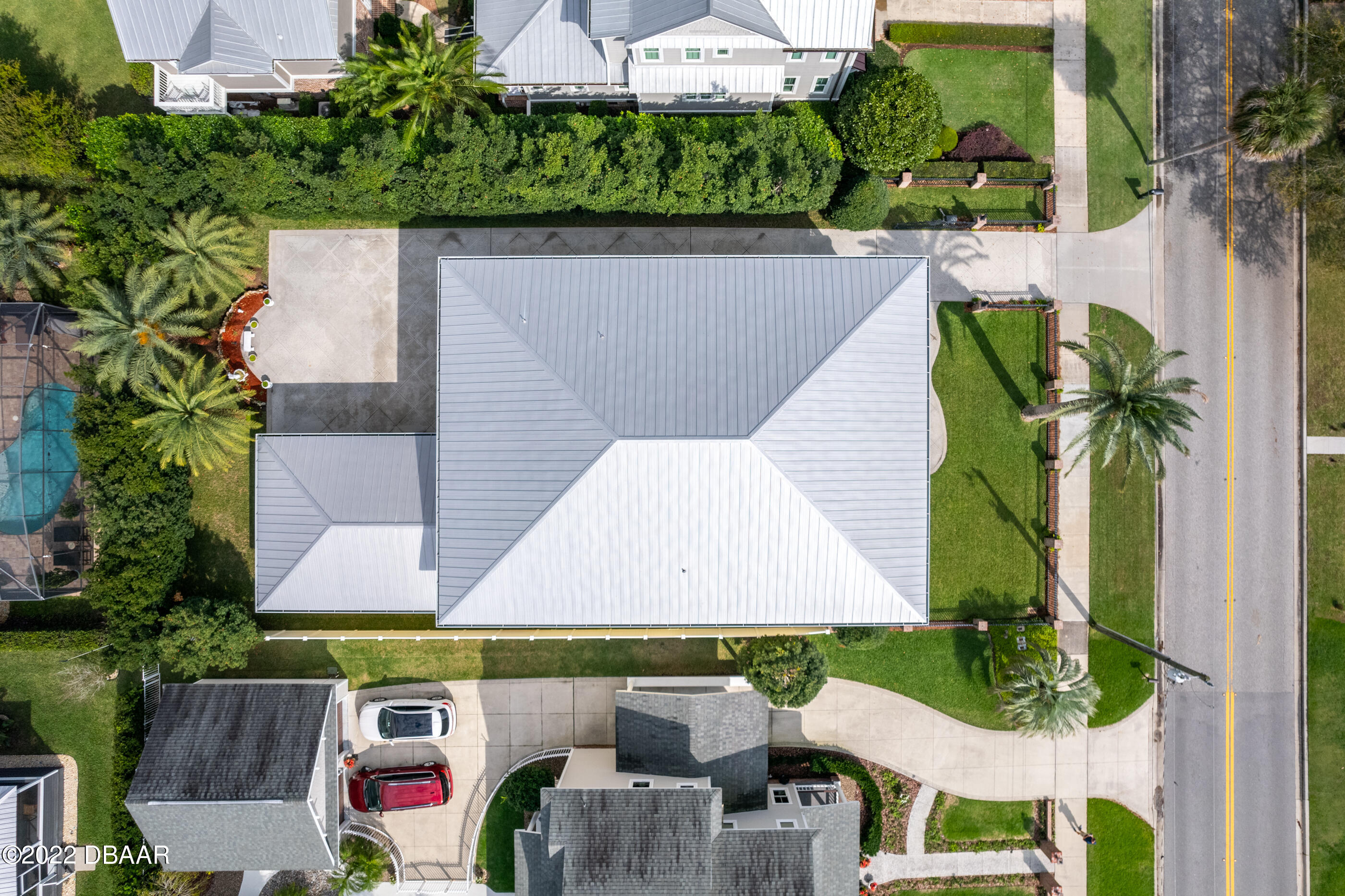 1212 South Riverside Drive New Smyrna Beach, FL 32168 - Photo 11 of 49 an aerial view of a house with garden space and a car park