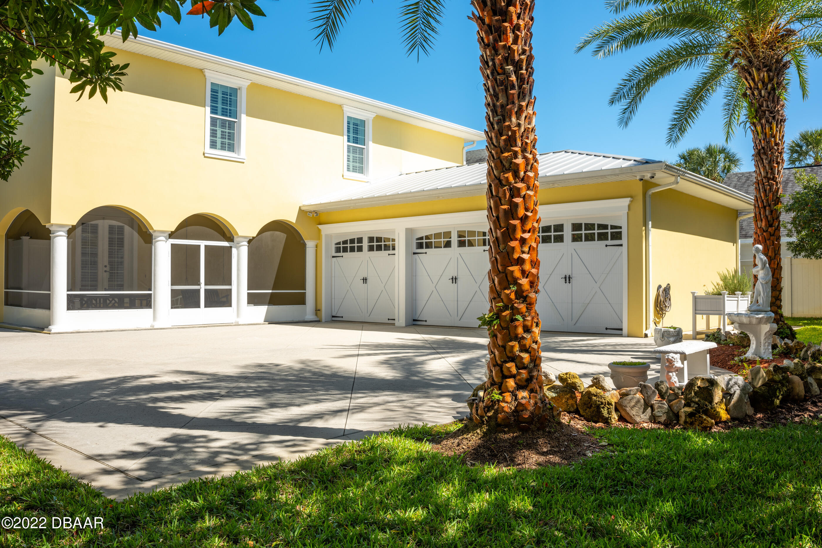 1212 South Riverside Drive New Smyrna Beach, FL 32168 - Photo 13 of 49 a front view of a house with a yard and garage