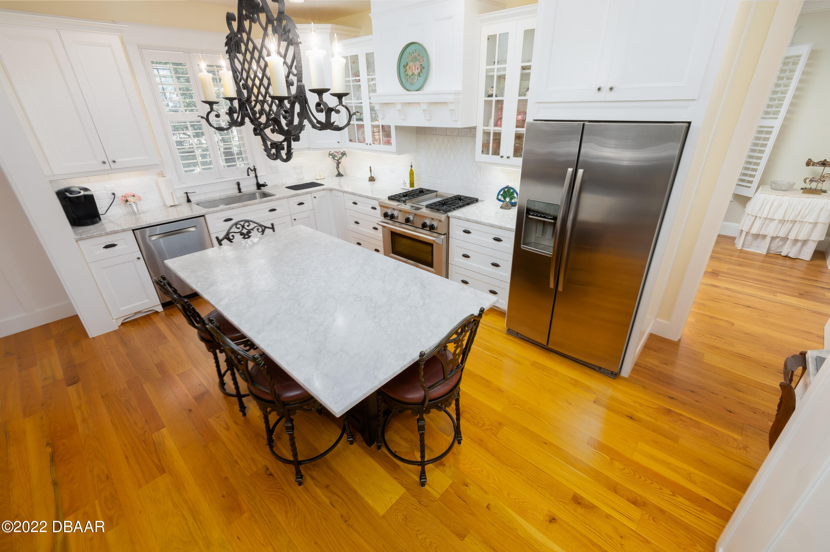 1212 South Riverside Drive New Smyrna Beach, FL 32168 - Photo 15 of 49 a kitchen with stainless steel appliances granite countertop a sink a stove and a refrigerator