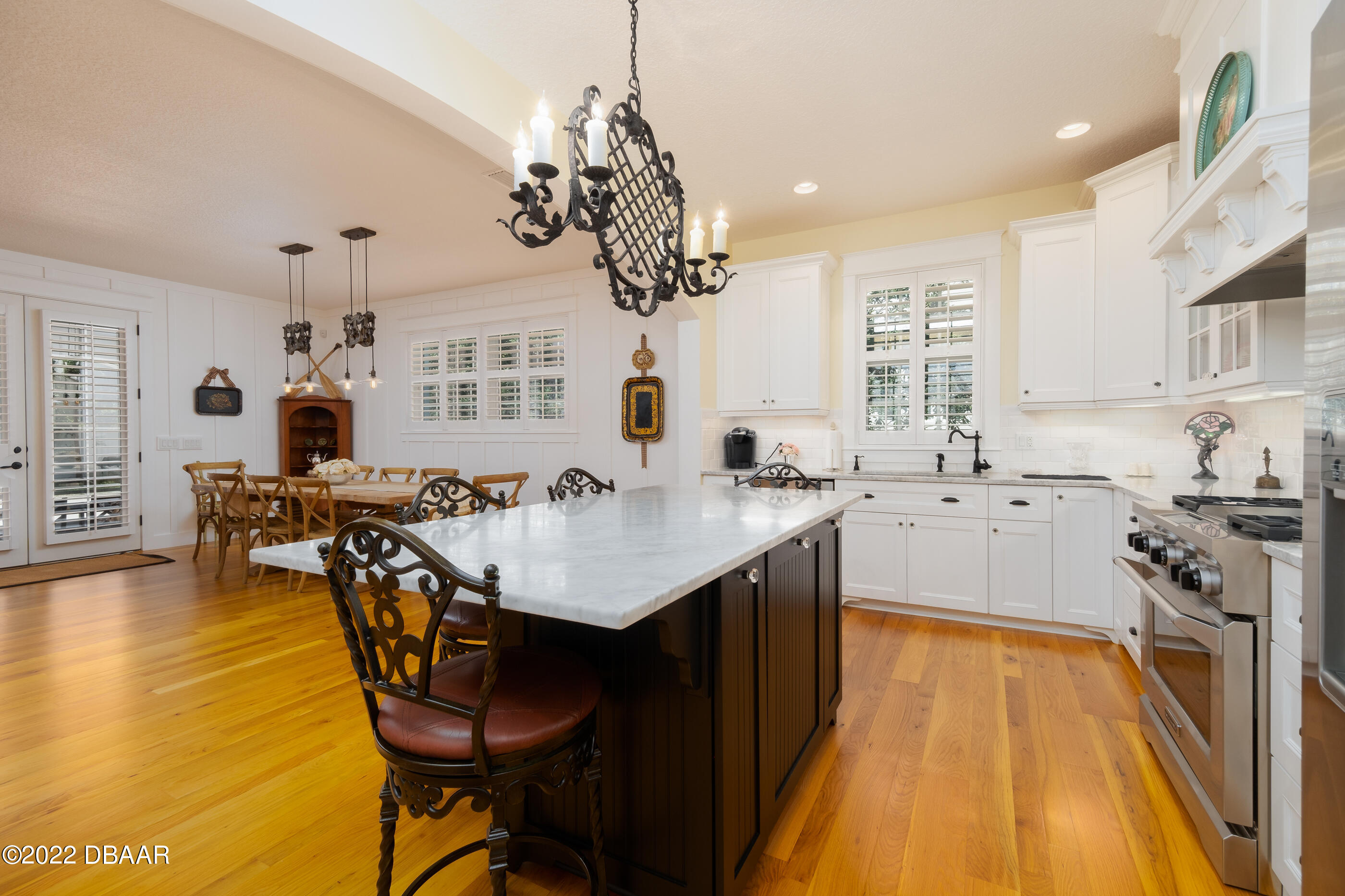 1212 South Riverside Drive New Smyrna Beach, FL 32168 - Photo 16 of 49 a kitchen with stainless steel appliances a table and chairs in it