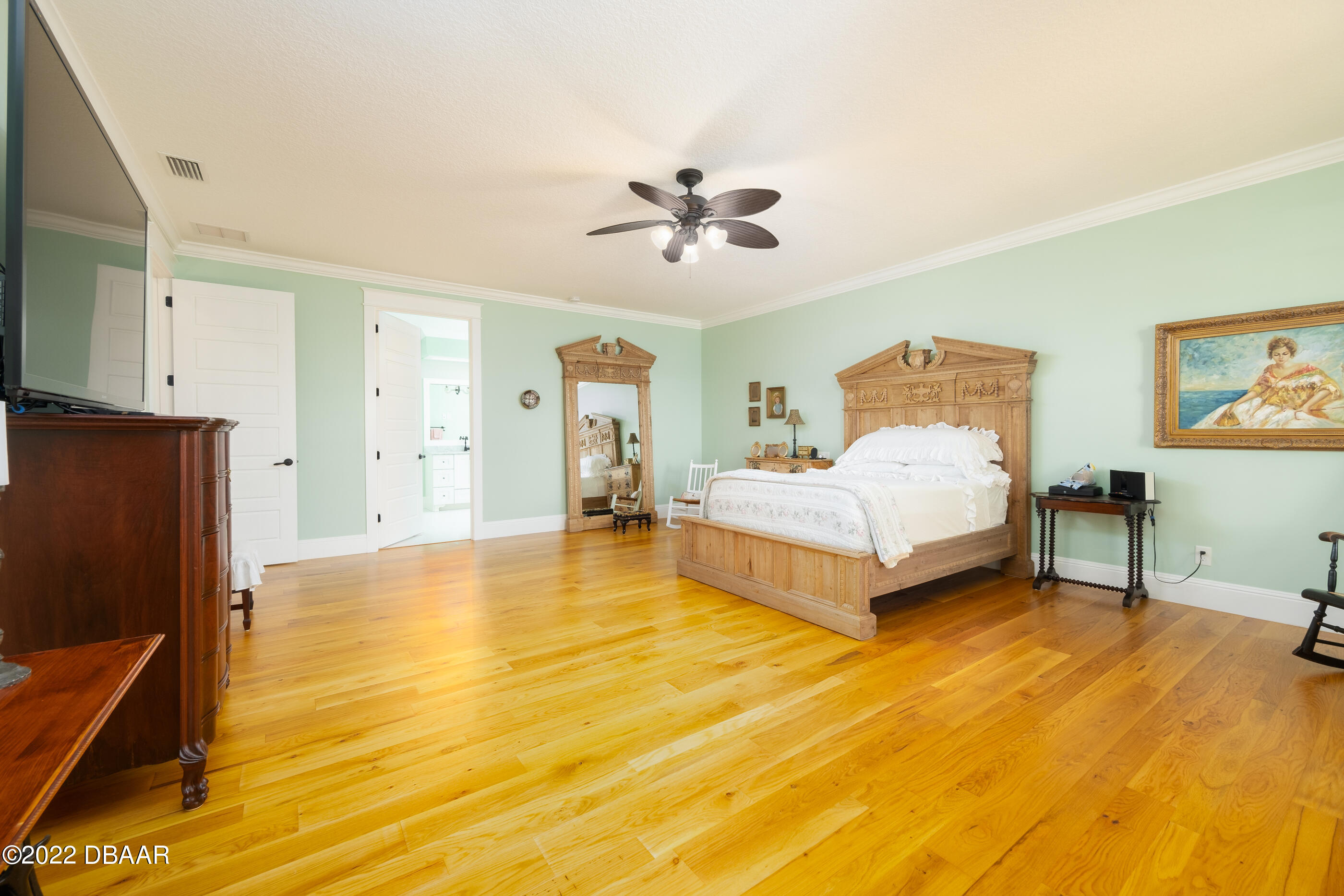 1212 South Riverside Drive New Smyrna Beach, FL 32168 - Photo 27 of 49 a spacious bedroom with a bed and a flat screen tv